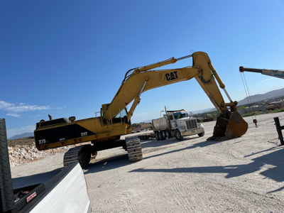 Excavator with mass ex stick and bucket or rock bucket