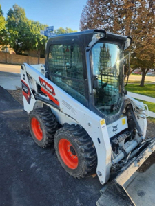 Enclosed can skid steer.